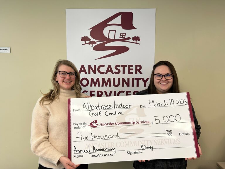 image of Jocelyn and Kaylee holding a large cheque from Albatross Indoor Golf Centre for $5000